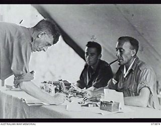 ALEXISHAFEN, NEW GUINEA. 1944-06-16. THE PAY FOR TROOPS IN THE NORTH ALEXISHAFEN AREA BEING PREPARED AT HEADQUARTERS, 15TH INFANTRY BRIGADE. LEFT TO RIGHT: VX26757 PRIVATE R. DILLON, 2/1ST GUARD ..