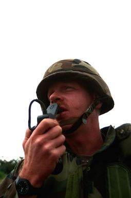 SPECIALIST 1ST Class Brian R. Anderson, platoon sergeant with Co. B, 1ST Plt., 4th Bn., 27th Inf., 25th Inf. Div. (Light), communicates with his unit as he prepares them for deployment to the Middle East to take part in Operation Desert Storm