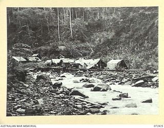 DUMPU AREA, NEW GUINEA. 1944-04-18. THE CAMP OF THE 15TH FIELD COMPANY, ROYAL AUSTRALIAN ENGINEERS SITUATED ALONGSIDE THE FARIA RIVER DURING CONSTRUCTION OF THE ROAD