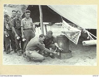 HANSA BAY-BOGIA HARBOUR, NEW GUINEA. 1944-08-09. B/248 MR. A. SCOTT, WELFARE OFFICER, YOUNG MEN'S CHRISTIAN ASSOCIATION SERVING COFFEE TO THE TROOPS IN THE UNIT WELFARE TENT. IDENTIFIED PERSONNEL ..