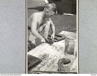 THORPVILLE, NEW GUINEA. 1943-12-07. V265623 PRIVATE J.R. CALVERT 56/59TH AUSTRALIAN INFANTRY BATTALION DOING CARPENTRY WORK AS THERAPY TREATMENT FOR A BADLY WOUNDED RIGHT SHOULDER AT THE 113TH ..