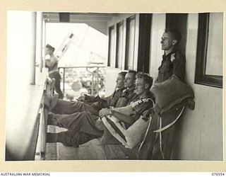 AT SEA. 1944-10-07. OFFICERS OF THE 36TH INFANTRY BATTALION RELAXING ON THE DECK OF THE DUTCH TROOPSHIP "SWEARTENHONDT" WHILE EN ROUTE TO NEW BRITAIN. IDENTIFIED PERSONNEL ARE:- QX40803 LIEUTENANT ..