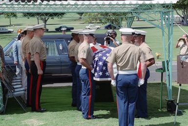 Lieutenant General (LGEN) Charles Cooper (first row, end), commanding general, Fleet Marine Force, Pacific, attends the funeral of an unknown Marine at Punch Bowl Cemetery. The remains were found at Henderson Field, Guadalcanal