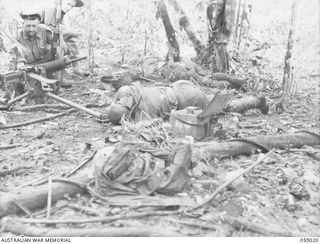 FARIA VALLEY, NEW GUINEA, 1943-10-17. BODIES OF JAPANESE DEAD, AROUND A TYPE 92 "WOODPECKER" MACHINE GUN AFTER 2/27TH AUSTRALIAN INFANTRY BATTALION HAD CAPTURED TREVOR'S RIDGE. SHOWN: NX127113 ..