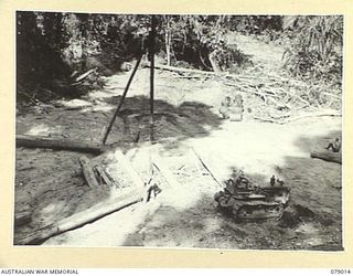 TOROKINA AREA, BOUGAINVILLE ISLAND. 1945-02-10. THE LOADING POINT OF NO 3 PLATOON, 2/2ND FORESTRY COMPANY AS SEEN FROM THE TOP OF THE SLIDE. IDENTIFIED PERSONNEL ARE:- CORPORAL N.M. TRELOAR (1); ..