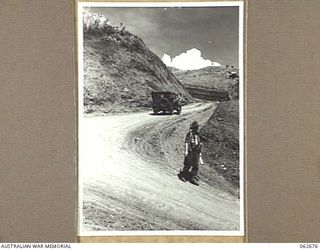 LAKE ROAD, FINISTERRE RANGES, NEW GUINEA. 1943-12-21. A SECTION OF THE LAKE ROAD IN THE FOOTHILLS OF THE FINISTERRE RANGES WHICH WAS BUILT BY THE ROYAL AUSTRALIAN ENGINEERS, UNITS OF THE 7TH ..