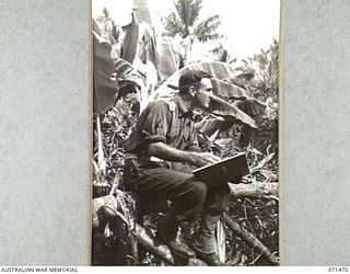 VX93432 Captain Roy Cecil Hodgkinson, a Military History Section war artist, working in the area