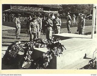 LAE, NEW GUINEA. 1944-04-23. MEMBERS OF THE AUSTRALIAN ARMY NURSING SERVICE FROM THE 2/7TH GENERAL HOSPITAL EXAMINING WREATHS LAID DURING THE DEDICATION CEREMONY AT THE LAE WAR CEMETERY. THE ..