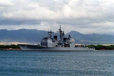 A port bow view of the guided missile cruiser USS VALLEY FORGE (CG-50) departing Pearl Harbor through the channel.