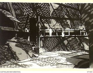 PORT MORESBY, PAPUA, NEW GUINEA. 1944-03-27. THE INTERIOR OF THE BOOM SECTION GUN EMPLACEMENT AT PAGA BATTERY, COAST ARTILLERY. THE DOOR LEADS TO THE MAGAZINE AND ARTILLERY STORE WITH THE GUN FLOOR ..