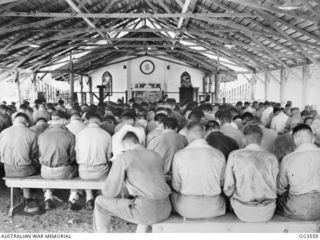 TOROKINA, BOUGAINVILLE ISLAND, SOLOMON ISLANDS. 1945-08-16. THE CONGREGATION AT A THANKSGIVING SERVICE FOR RAAF PERSONNEL HELD IN THE CHURCH OF ENGLAND CHAPEL, CONDUCTED BY PADRE ROSS BORDER OF ..