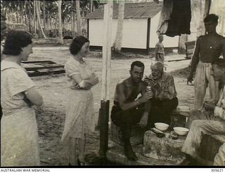 EMIRAU ISLAND. 1940-12. PASSENGERS AND CREW, AMONG THE 496 SURVIVORS WHO HAD BEEN CAST AWAY ON EMIRAU ISLAND IN THE BISMARCK ARCHIPELAGO AFTER THEIR MERCHANT SHIPS HAD BEEN SUNK BY GERMAN RAIDERS ..