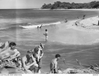 KELANOA AREA, NEW GUINEA. 1944-01-22. TROOPS OF THE 2/15TH INFANTRY BATTALION WASHING THEIR CLOTHES AND SWIMMING IN THE FRESH WATER AT THE MOUTH OF THE SAZOMU RIVER, AFTER HAVING MARCHED FROM SIO ..