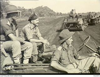 BUT, NORTHERN NEW GUINEA. 1945-04-02. FLYING OFFICER J. C. RUSH OF EARLWOOD, NSW (CENTRE), PILOT OF A RAAF AUSTER AIR AMBULANCE AIRCRAFT WHICH ARE ENGAGED IN FLYING CRITICALLY WOUNDED AUSTRALIAN ..