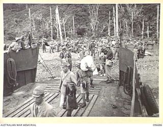 KAIRIRU ISLAND, NEW GUINEA. 1945-09-17. JAPANESE NAVAL OFFICERS EMBARKING ON BARGE FOR TRANSFER TO MUSCHU ISLAND. FOLLOWING THE SURRENDER OF THE JAPANESE THE ISLANDS ARE NOW UNDER THE CONTROL OF HQ ..