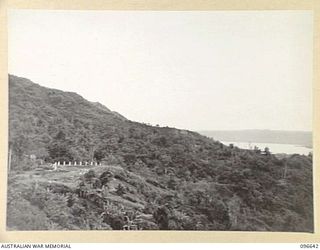 RABAUL, NEW BRITAIN. 1945-09-14. VIEW LOOKING DOWN ON THE RUINS OF THE FORMER GOVERNMENT HOUSE AT RABAUL. SIMPSON HARBOUR IN BACKGROUND. FOLLOWING THE SURRENDER OF THE JAPANESE, HEADQUARTERS 11 ..