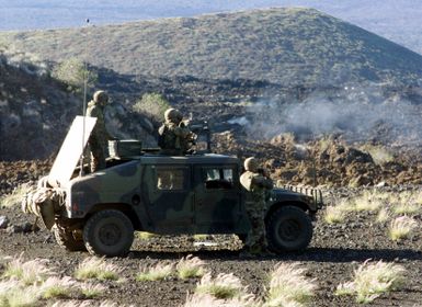 US Marines from 2nd Battalion, 3rd Marines, Weapons Company, aboard a High-Mobility Multipurpose Wheeled Vehicle (HMMWV) fire a 50 Caliber gun during a Combined Arms Live Fire Exercise at Pohakuloa Training Area on the Big Island of Hawaii