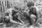 Bono and another man working with string of kofu shell money