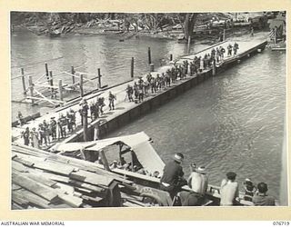 MILFORD HAVEN, LAE, NEW GUINEA. 1944-11-01. TROOPS OF HEADQUARTERS, 3RD DIVISION LINED UP ON THE FLOATING WHARF AT MILFORD HAVEN PRIOR TO THEIR EMBARKATION ABOARD THE AMERICAN LIBERTY SHIP, LINDLEY ..