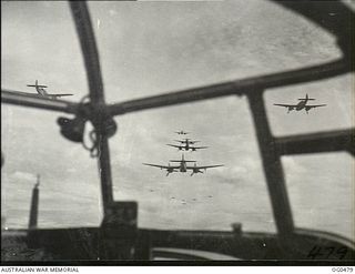 AIRBORNE EN ROUTE TO LINDENHAFEN, NEW BRITAIN. 1944-01-17. VIEW THROUGH THE NOSE OF A BEAUFORT BOMBER AIRCRAFT OF NO. 100 SQUADRON RAAF. BEAUFORT BOMBER AIRCRAFT OF NOS. 6, 8 AND 100 SQUADRONS RAAF ..