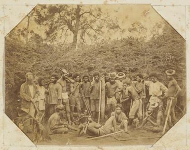 Large group of Kanak men holding various implements as part of a working party, Saint-Louis, New Caledonia, ca. 1870s / Allan Hughan