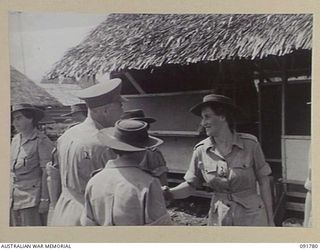 LAE, NEW GUINEA. 1945-05-14. LIEUTENANT GENERAL V.A.H. STURDEE, GENERAL OFFICER COMMANDING FIRST ARMY (2), SHAKING HANDS WITH LIEUTENANT M. BEARD (3), DURING HIS INSPECTION OF THE AUSTRALIAN ..