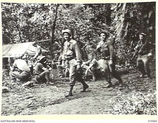 1943-08-14. NEW GUINEA. MOUNT TAMBU FIGHTING. THE "VILLAGE SQUARE" AT BUIGAP. THIS IS A RESTING PLACE FOR ALLIED TROOPS GOING TO AND COMING FROM THE FIGHTING AT MOUNT TAMBU. THE TARPAULIN COVERED ..