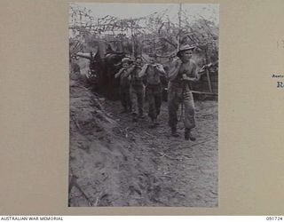 HAWAIN, WEWAK AREA, NEW GUINEA. 1945-05-09. A GUN CREW OF 2/3 FIELD REGIMENT RUNNING A PULL THROUGH DOWN THE GUN BARREL OF A "LONG TOM" 155MM GUN. THE WEAPON IS BEING USED TO SUPPORT THE ATTACK ..