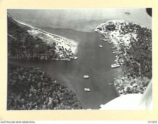 LAE, NEW GUINEA. 1944-03-30. AN AERIAL VIEW SHOWING CRAFT IN LABU LAGOON, AND THE WINGTIP OF THE AIRCRAFT IN THE RIGHT FOREGROUND