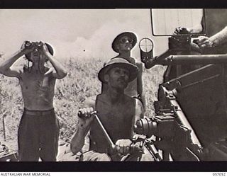 NADZAB AREA, NEW GUINEA. 1943-09-20. PERSONNEL OF THE 11TH BATTERY, 2/4TH AUSTRALIAN LIGHT ANTI-AIRCRAFT REGIMENT MANNING THEIR 40MM BOFORS GUN, AWAITING THE SECOND WAVE OF JAPANESE RAIDERS. LEFT ..