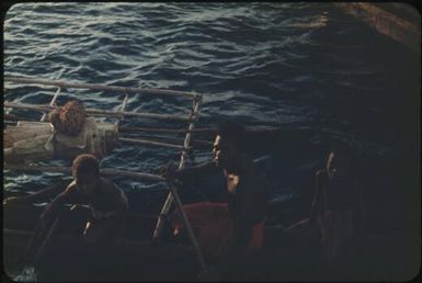 A man and two native boys in an outrigger canoe coming to meet the trawler : Tasman Islands, Papua New Guinea, 1960 / Terence and Margaret Spencer