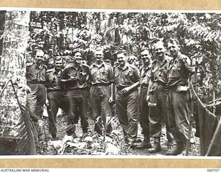 FINSCHHAFEN, NEW GUINEA. 1943-10-30. OFFICERS OF HEADQUARTERS, 26TH AUSTRALIAN INFANTRY BRIGADE. THEY ARE, LEFT TO RIGHT: NX12355 CAPTAIN B. STANILANDS; VX36046 CAPTAIN T. H. MATTHEWS; NX12365 ..