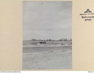 SANANANDA, NEW GUINEA, 1945-07-03 TO 1945-07-04. A WRECKED JAPANESE LANDING CRAFT ON SANANANDA BEACH