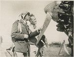 Ernie Smith standing beside the "City of Oakland" which he flew to Hawaii in the Dole Race in summer of 1928