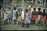 Group of women dancers; women in front with shield and spear