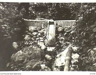 LAE, NEW GUINEA. 1944-04-01. A DAM BUILT AT THE BUSU RIVER, BY ROYAL AUSTRALIAN ENGINEERS, HEADQUARTERS LAE BASE SUB AREA FOR THE SUPPLY OF WATER TO HOSPITALS. THE DAM, SHOWING THE OUTLET HANDLING ..