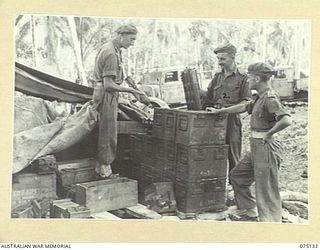 POTSDAM-HANSA BAY AREA, NEW GUINEA. 1944-07-31. NX112700 CAPTAIN H.R. WILBY (1), NX112704 CAPTAIN W.L. CHARGE (2) AND NX112004 LIEUTENANT J.H.G. ROFFEY (3) INSPECTING AMMUNITION AT THE REAR ..