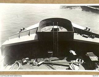 SYDNEY, NSW. 1944-01-22. BOFORS GUN NEST BEING FITTED IN THE BOWS OF THE MV "FRANCES PEAT" BEFORE THE SHIP IS PUT INTO SERVICE WITH THE AUSTRALIAN SMALL CRAFT SECTION IN NEW GUINEA WATERS