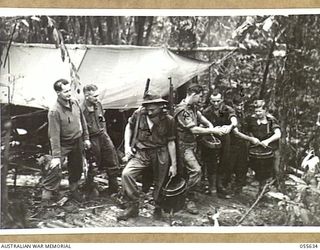 GOODVIEW, NEW GUINEA, 1943-08-10. TROOPS OF "D" COMPANY, 2/6TH BATTALION, TAKING FOOD FROM THE "D" COMPANY COOKHOUSE, TO A FRONT LINE PLATOON. LEFT TO RIGHT:- VX4075 ACTING SERGEANT A. J. FARTHING; ..