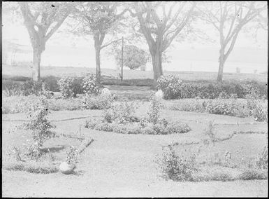 Looking across garden past the stone sentinels towards the harbour, Chinnery's garden, Malaguna Road, Rabaul, New Guinea, ca. 1936 / Sarah Chinnery