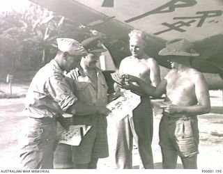 THE SOLOMON ISLANDS, 1945-08. AUSTRALIAN AND NEW ZEALAND SERVICEMEN STUDY PAMPHLETS TO BE AIR-DROPPED TO JAPANESE SERVICEMEN CONCERNING CESSATION OF HOSTILITIES IN THE BOUGAINVILLE ISLAND AREA. THE ..