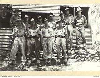 PORT MORESBY, PAPUA, 1944-02-20. A GROUP OF OFFICERS OF THE 5TH AUSTRALIAN CHIEF ENGINEER (WORKS), ROYAL AUSTRALIAN ENGINEERS (A.I.F.), PICTURED OUTSIDE THEIR HEADQUARTERS. IDENTIFIED PERSONNEL ..