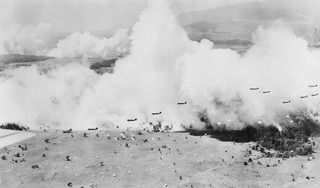 THE LANDING OF THE 503RD AMERICAN PARACHUTE INFANTRY REGIMENT AT NADZAB ON 1943-09-05. ONE BATTALION IS LANDING IN THE FOREGROUND AND IN THE LEFT BACKGROUND ANOTHER BATTALION RINGED BY SMOKE CAN BE ..