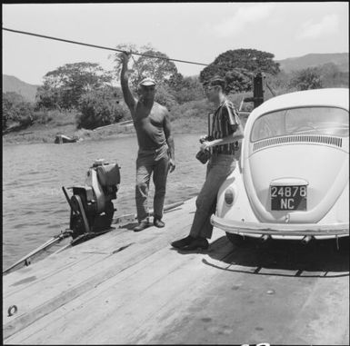 Two men with a volkswagen on a motorised punt, New Caledonia, 1967 / Michael Terry