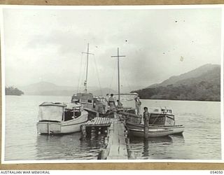 KWIARA, CHINA STRAITS, 1943-07-06. SMALL CRAFT OF THE 1ST AUSTRALIAN WATER TRANSPORT GROUP (SMALL CRAFT) TIED UP AT THE JETTY