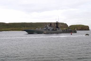 The Russian Federated Navy (RFN) ship MARSHAL SHAPOSHNIKOV (RFN 543), navigates through Apra Harbor, Guam (GU), as a US Navy (USN) Harbor Patrol Boat (HPB) secures the area. The SHAPOSHNIKOV is one of four RFN ships and two US Navy (USN) ships, which participated in Passing Exercise (PASSEX) 2006, off the coast of Guam