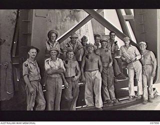 LAE, NEW GUINEA. 1943-10-12. MEMBERS OF THE UNITED STATES SMALL SHIPS SECTION. THIS SECTION DOES SALVAGE WORK IN AND AROUND THE HARBOUR AND HAS PARTICULAR INTEREST AS IT IS MADE UP OF UNITED STATES ..