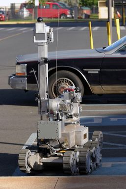 A Remote Operated Neutralization System is ready to move in on a car suspected to contain a simulated bomb while during training at the Marine Corps Base Hawaii, Hawaii, Post Exchange parking lot on Dec. 9, 2004.(U.S. Marine Corps official photo by CPL. Nicholas Riddle) (Released)