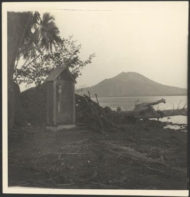 Shrine containing a crucifix surrounded by volcanic eruption devastation, Rabaul, New Guinea, 1937 / Sarah Chinnery