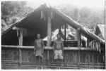 Two men in front of house